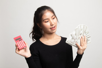 Portrait of  young asian woman  showing bunch of money banknotes.