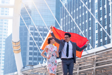 Business man and woman in Chinese dress make gestures excited, Men celebrate Chinese flag in a modern city, Chinese new year