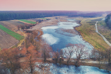 Rural landscape. Aerial view of the frozen river in winter