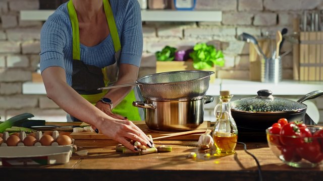 Woman Cooking In Kitchen. Real People, Authentic, No Face.