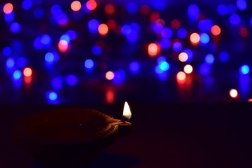 Diya lamps lit with bokeh background during diwali celebration