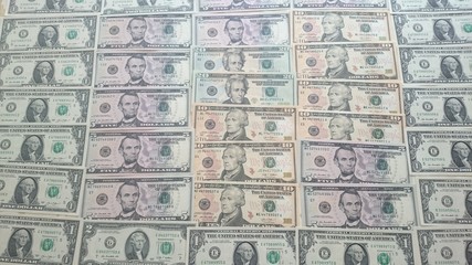 Us dollar bills arranged in the form of bricks  . 1 us dollar, 5 us dollars, 20 us dollars. 