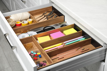 Fototapeta na wymiar Different stationery in open desk drawer indoors
