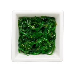 Ohitashi - Japanese vegetable salad in a square bowl isolated on white background