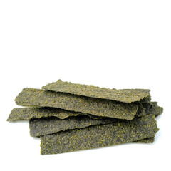 Close-up of Crispy dried seaweed, Nori chips piece of roasted seaweed sheet isolated on white background, macro or close-up Healthy food concept, flat lay roasted seaweed © ric