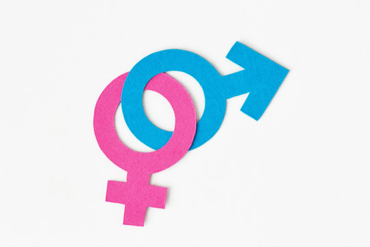 Male and female gender symbols chained together on white background - Gender relations concept