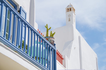 Picturesque scenic narrow streets with traditional whitewashed houses with blue doors windows of...