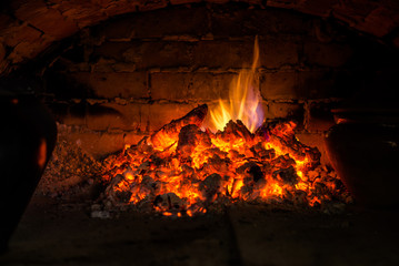 Obraz premium Village stove firewood and fire. Burning wood inside traditional oven