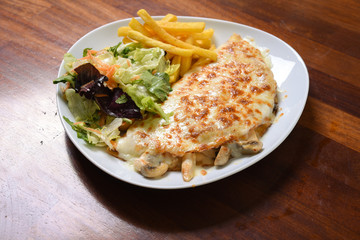 pancakes with chicken and vegetables, served with salad, served on a serving plate