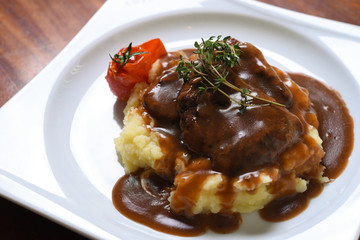 meat with barbecue sauce on mashed potatoes