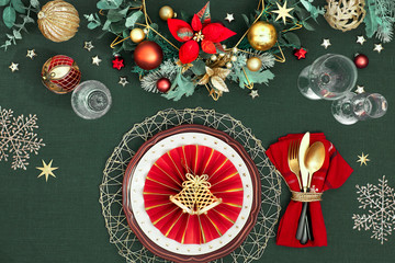 Christmas table setting in gold, burgundy and dark blue colors. Flat lay, top view on decorative...