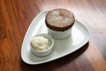 white souffle with chocolate sauce, powdered sugar and plain ice cream service details