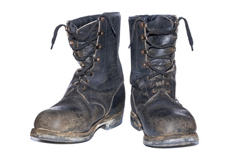 old soldier's boots worn with scratches and untied shoelaces. Old shabby leather boots isolated on...