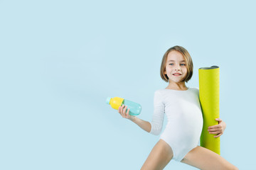 Little girl in a white leotard showing off over blue