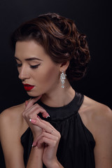 Beautiful gorgeous woman with elegant wavy hairstyle, bright make up.