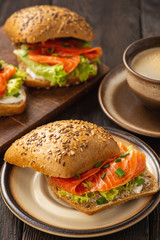 Sandwiches with salmon, lettuce and rye bread.