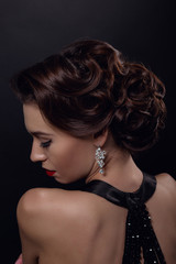 Beautiful gorgeous woman with elegant wavy hairstyle, bright make up.
