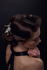 Beautiful gorgeous woman with elegant wavy hairstyle, bright make up.