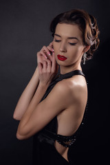 Beautiful gorgeous woman with elegant wavy hairstyle, bright make up.