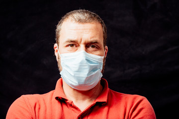 Mid aged adult man with surgical face mask