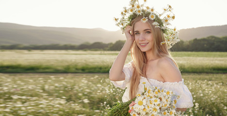 Fototapeta na wymiar portrait of a beautiful woman on meadow enjoying nature spring evening outdoors.
