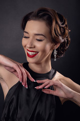 Beautiful gorgeous woman with elegant wavy hairstyle, bright make up.