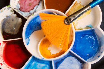 Watercolor paintings and paintbrush.