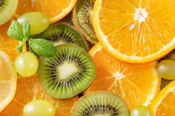 Fototapeta na wymiar orange , green grapes, kiwi, mint sprig fresh citrus, top view,