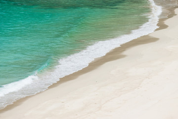 Fototapeta na wymiar white sandy beach and turquoise sea water on sunny day