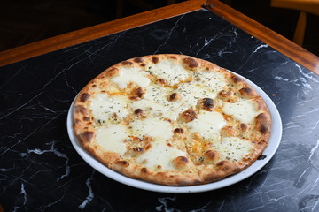 cheese pizza on black marble
