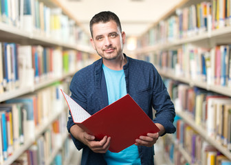 Young man wearing a blue outfit. Holding a red folder.