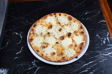 cheese pizza on black marble