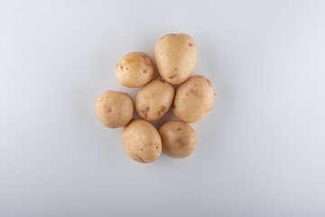 young white potatoes close-up on a white background