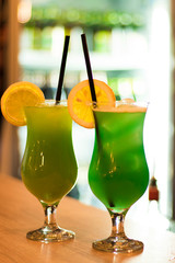 Colorful alcoholic drink, cocktail in the bar with juice and lemon
