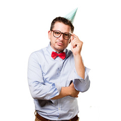 Man wearing a red bow tie and party hat. In a deep reflexion.