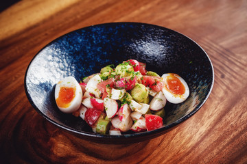 Vegetable salad with boiled eggs mixed with sour cream