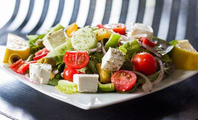 Vegetable Greece salad on the white plate