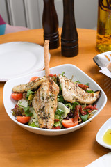 fried chicken, tomato, lettuce, cucumber, mixed salad ready for presentation