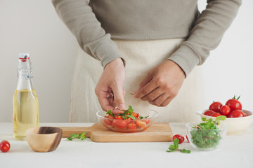Fresh delicious salad with tomatoes. Doing fresh green salad