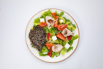Salad with turkey meat and rice noodles on a white background