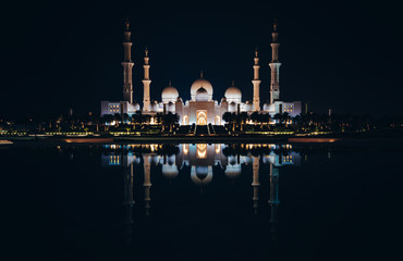Cheikh Zayed Mosque in Abu Dhabi at night with a beautiful reflection of the mosque in the water