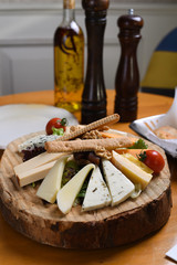 mixed cheese platter on wooden presentation background