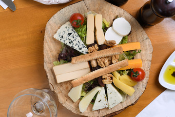 mixed cheese platter on wooden presentation background