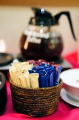 Sugar and creamer sachets on the coffee table