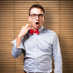 Man wearing a red bow tie. Looking weighed down.