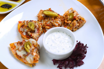Snack with potato wedges, chicken and cheddar