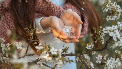 girl in blooming cherry garden on beautiful spring day