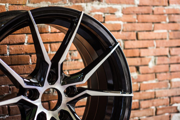 Luxury chrome alloy wheel in close-up as an automotive background.  Close up shot of a new car rim.
