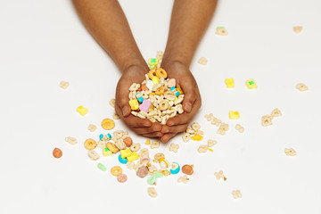 Women's hands on a white background hold assorted cookies, sweets, and corners .