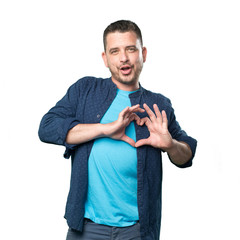Young man wearing a blue outfit. Doing a heart gesture.